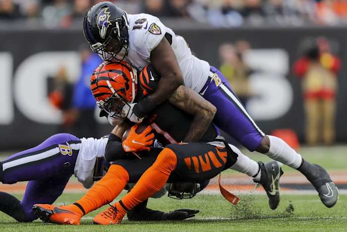 Jan 8, 2023; Cincinnati, Ohio, USA; Baltimore Ravens cornerback Damarion Williams (22) and linebacker Roquan Smith (18) bring down Cincinnati Bengals wide receiver Ja'Marr Chase (1) in the second half at Paycor Stadium. Mandatory Credit: Katie Stratman-USA TODAY Sports